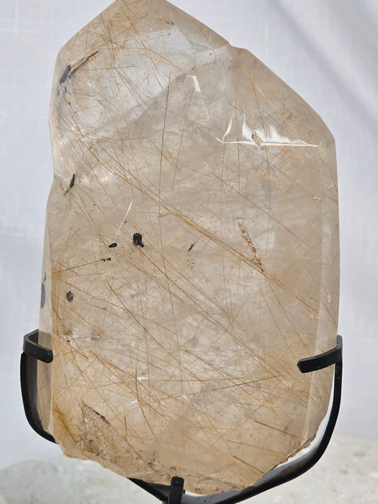 Gold/Copper Rutile in Quartz with Mica inclusions Point on stand